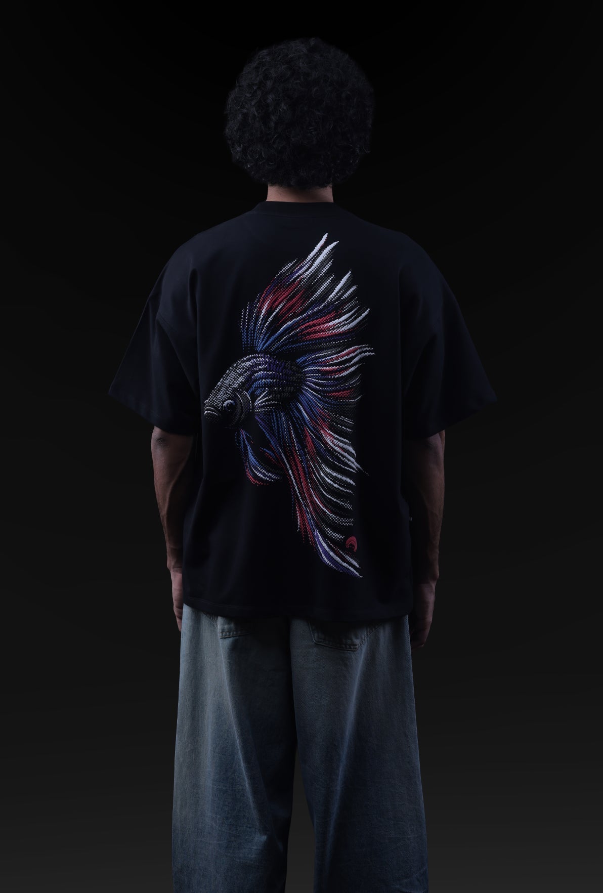 Person wearing a black t-shirt with a colorful bird design on the back against a dark background Crepdog Crew
