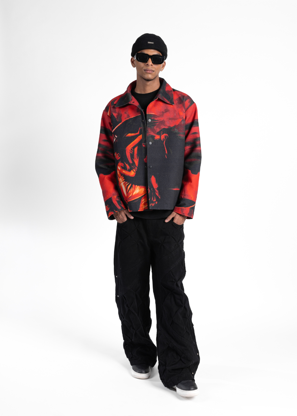 Person wearing a red and black jacket with a white background