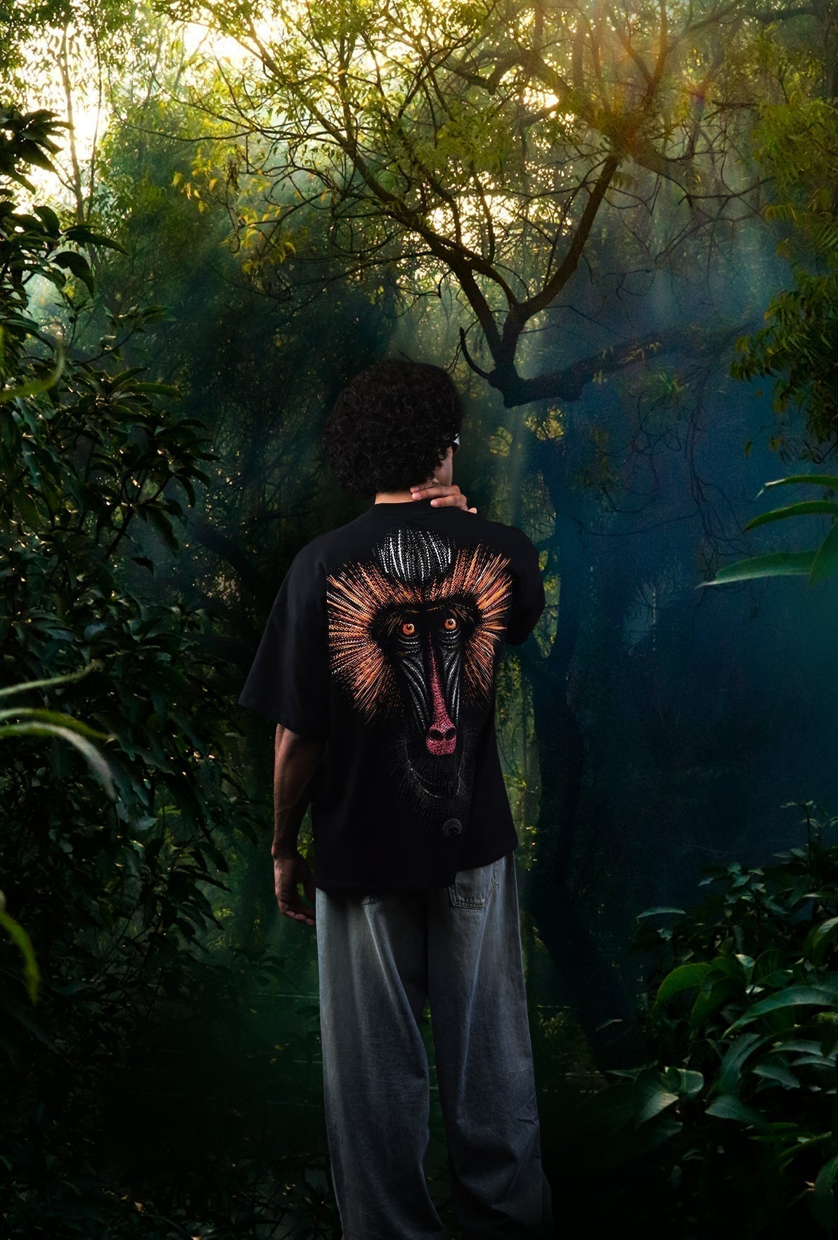 Person wearing a black t-shirt with a colorful graphic design in a forest setting Crepdog Crew