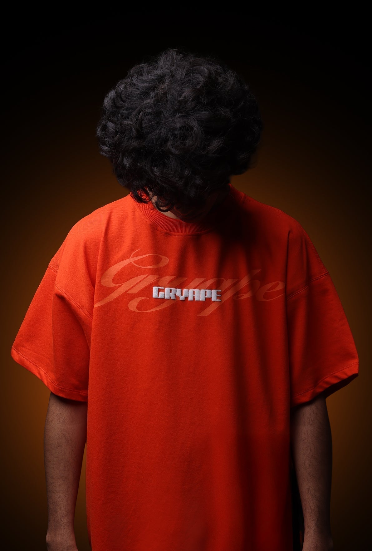 Person wearing a red shirt with 'Gryaffe' branding on a dark background - Crepdog Crew