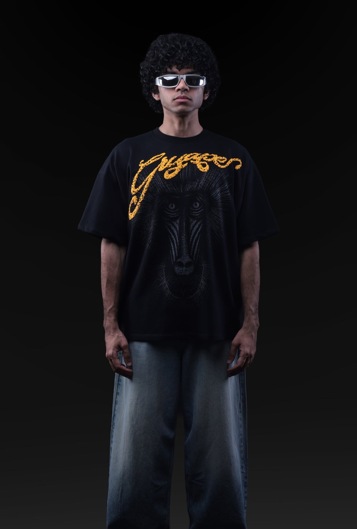 Person wearing a black t-shirt with yellow text and sunglasses on a black background Crepdog Crew