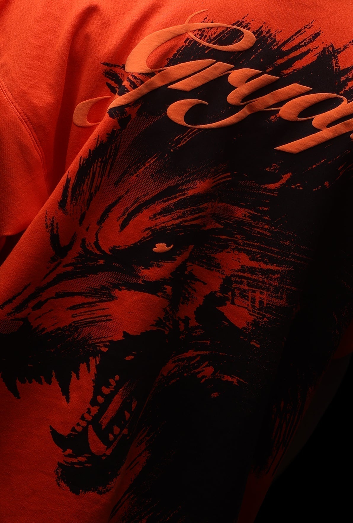 Red sweatshirt with a black wolf graphic and brand logo on an orange background - Crepdog Crew