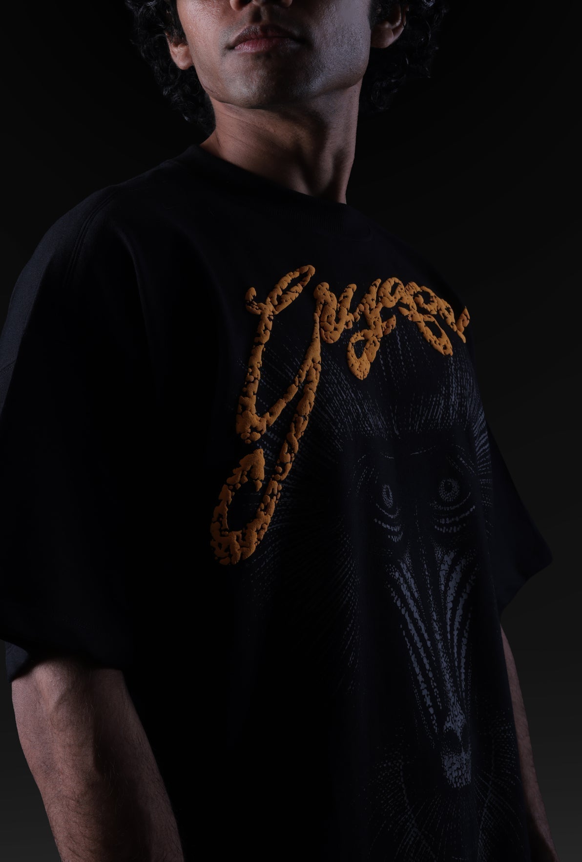 Person wearing a black t-shirt with yellow text and design on a dark background Crepdog Crew