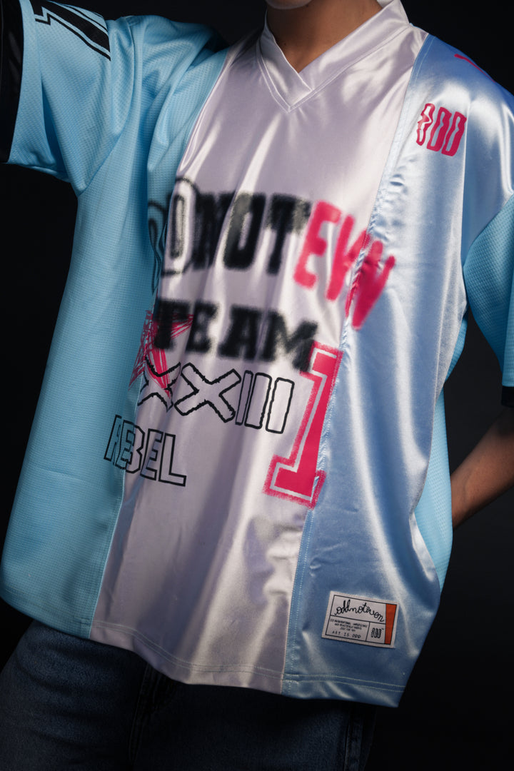 Person wearing a reflective sports jersey with text and branding - Crepdog Crew