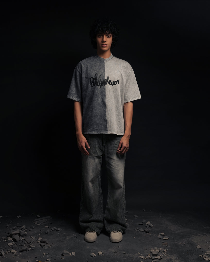 Person wearing a gray t-shirt with text on it against a black background - Crepdog Crew