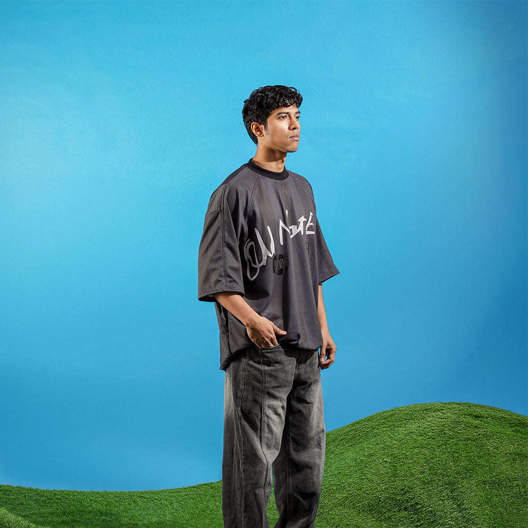 Person wearing a dark gray t-shirt with white text on a blue background Crepdog Crew