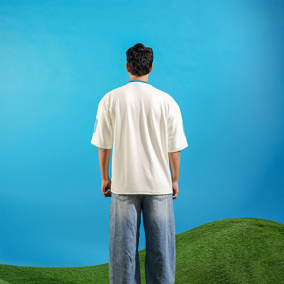 Man standing on a grassy hill with a clear blue sky Crepdog Crew