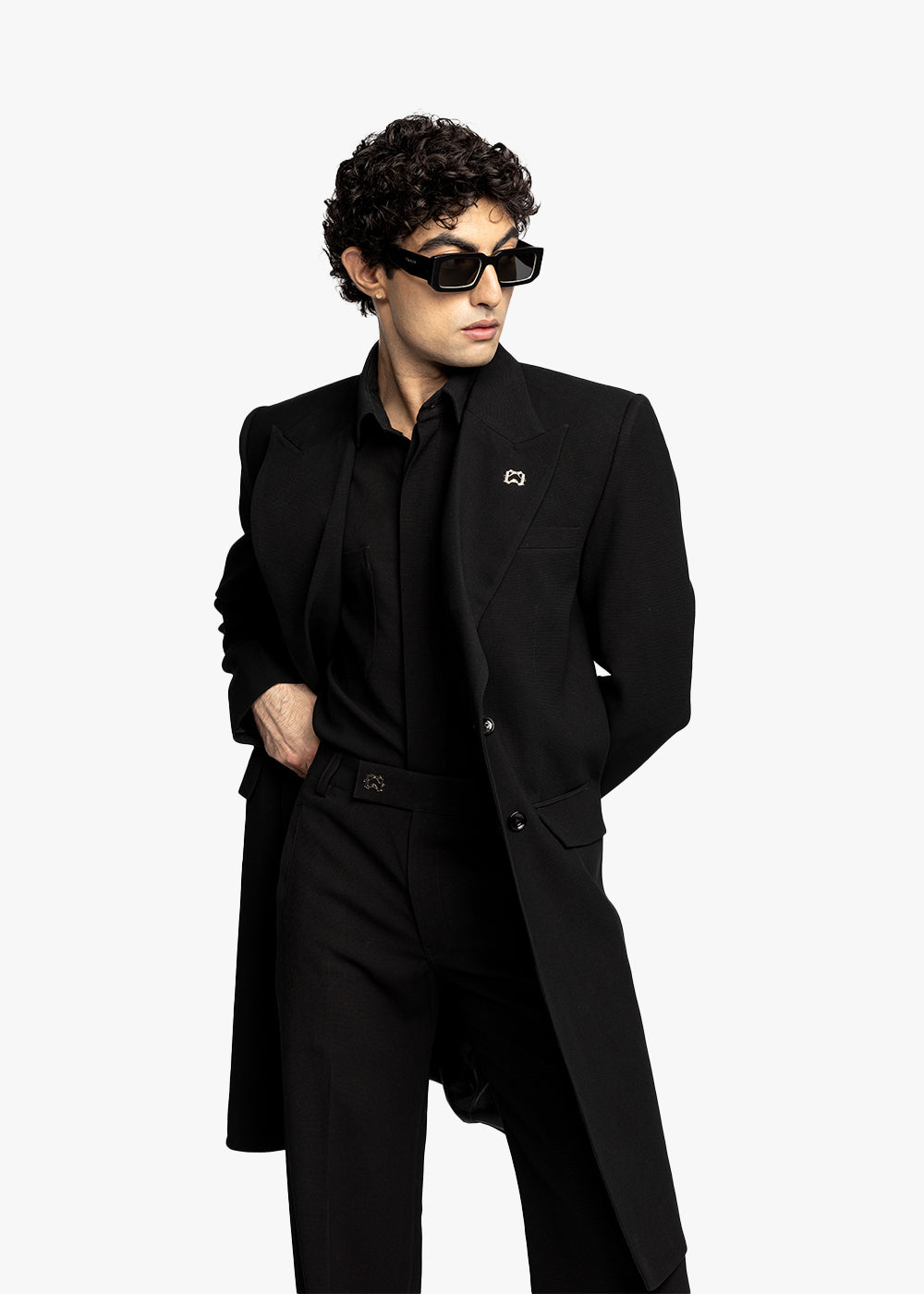 Person wearing a black coat and sunglasses on a white background - Crepdog Crew