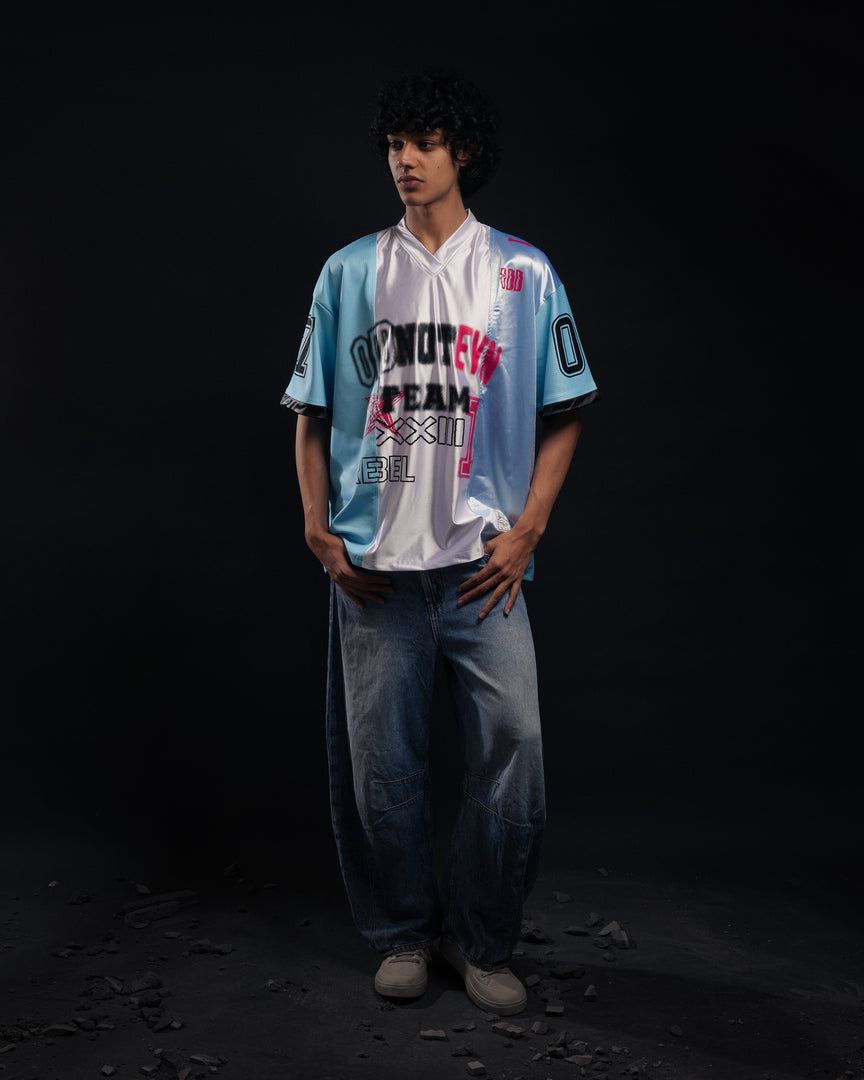 Person wearing a sports jersey with visible branding on a dark background - Crepdog Crew