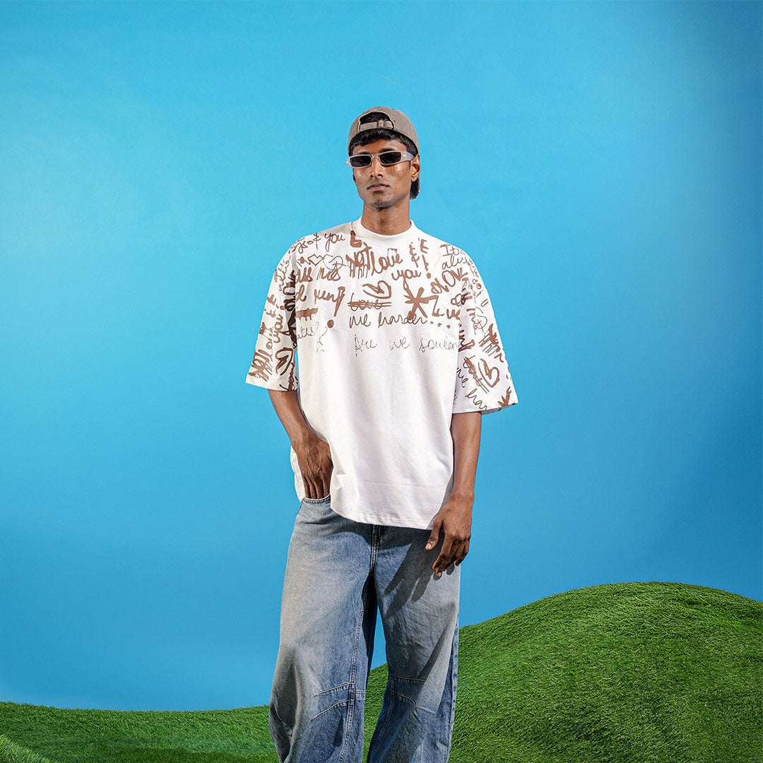 Man wearing a patterned shirt and sunglasses standing on grass with a blue sky background Crepdog Crew
