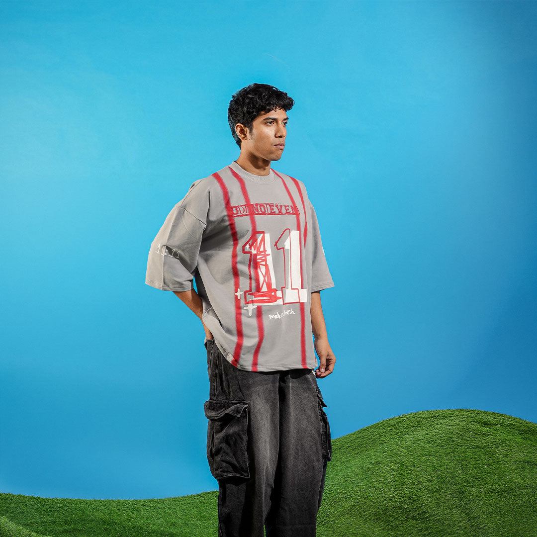 Person wearing a gray and red striped shirt with number 11 on a blue and green background Crepdog Crew