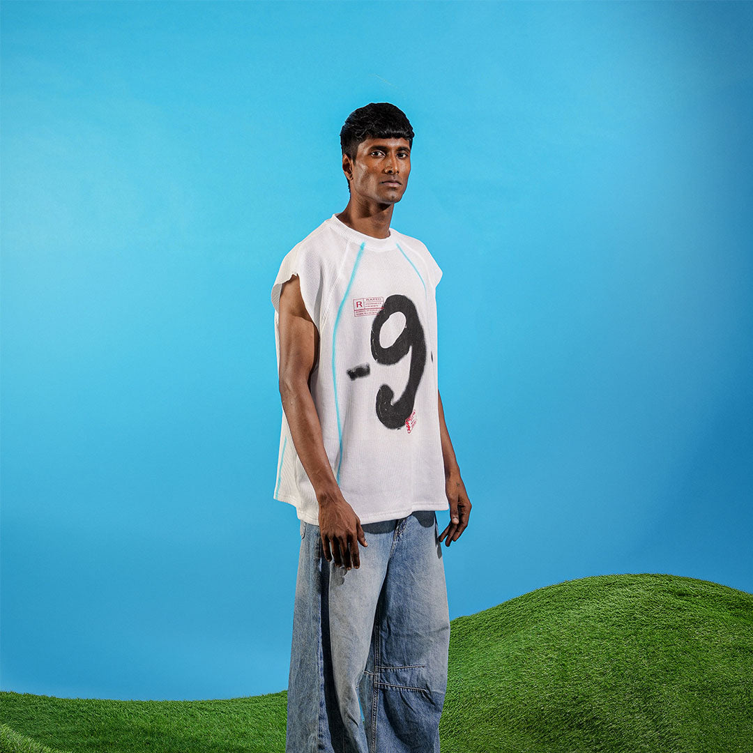 Person wearing a sleeveless shirt with the number 9 on a blue and green background Crepdog Crew