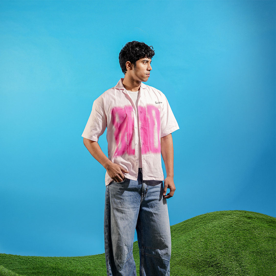 Person wearing a shirt with pink text on a blue sky and green grass background Crepdog Crew