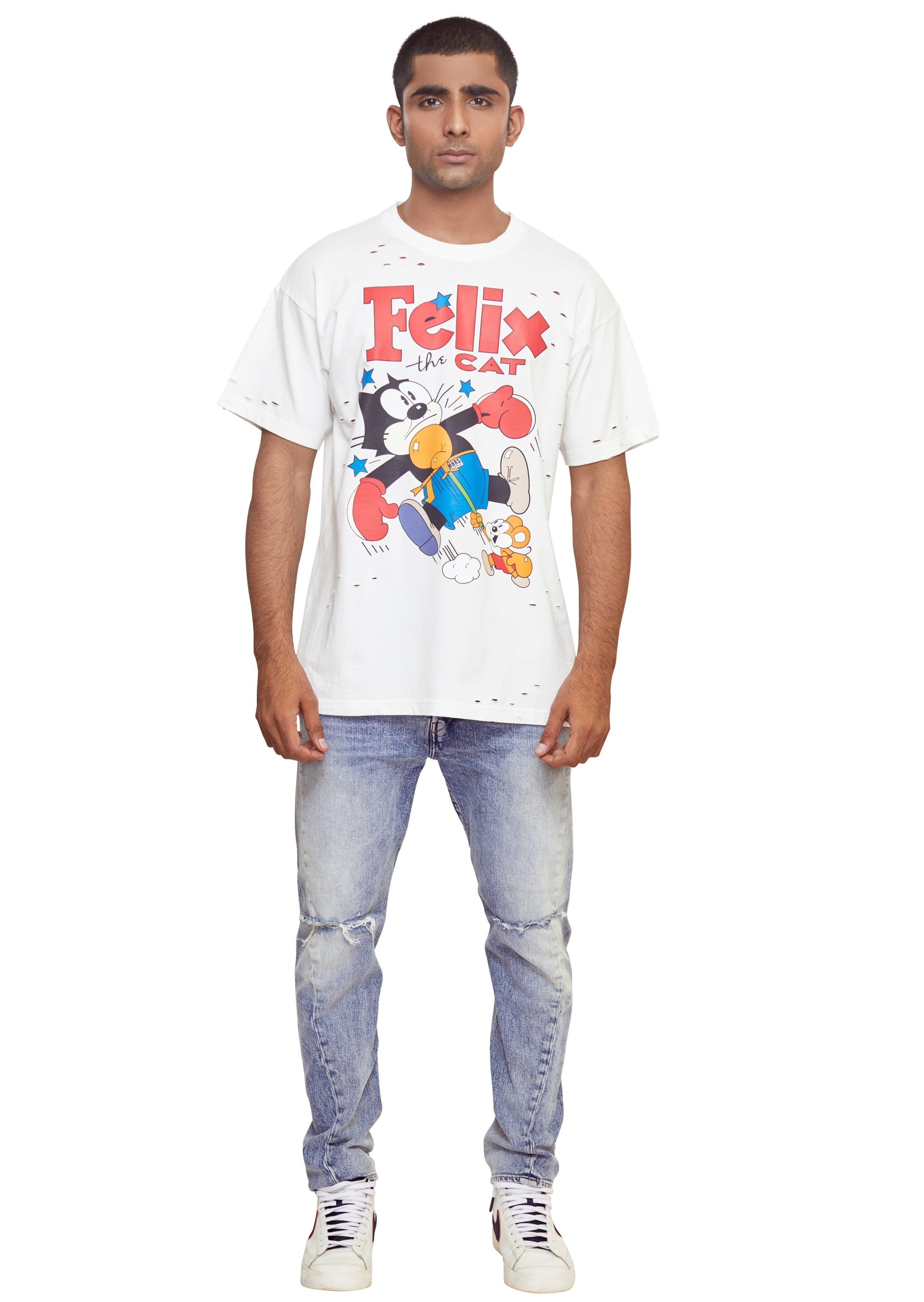 Off white cotton drop shoulder t shirt with Felix the Cat print to the front, punched holes, crew neck, short sleeves and straight hem from the brand Mostly Heard Rarely Seen